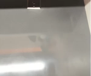 A professional corian countertop restoration in dubai — showing before and after transformation of a black corian surface with deep scratches removed, leaving a smooth, shiny, mirror finish counte.p