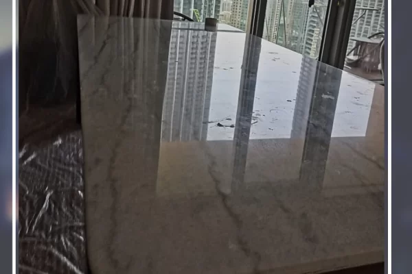 Marble tabletop before polishing – dull surface with stains and scratches in a dubai home.